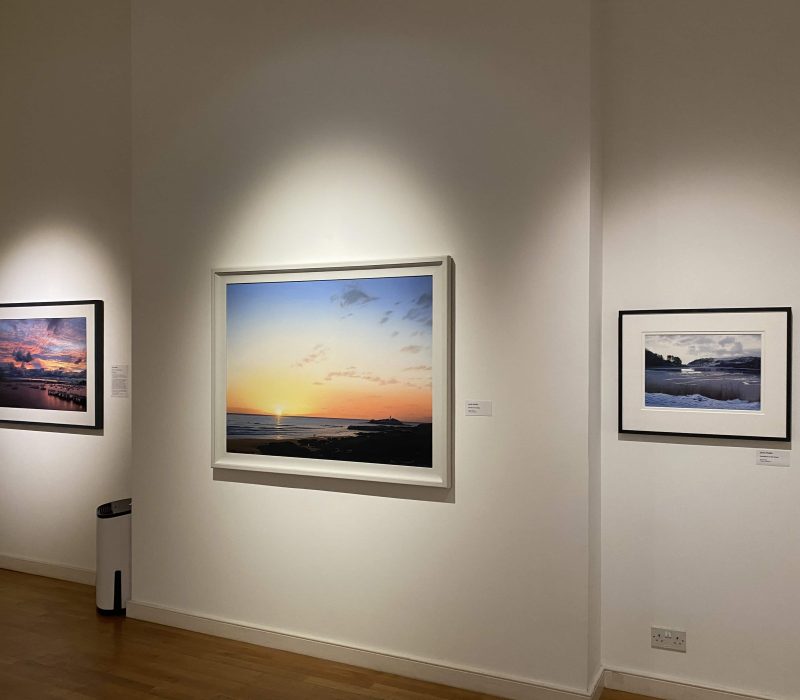 Framed seascape prints on the gallery wall at a Jamie Medlin exhibition